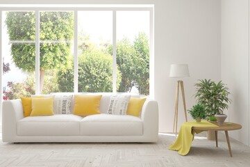 White living room with sofa and summer landscape in window. Scandinavian interior design. 3D illustration