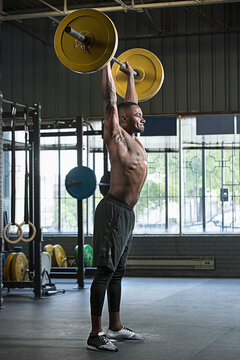 Black athlete lifting weights in gym