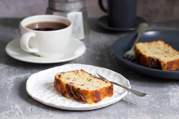 Banana muffin with candied ginger and raisins and drinks on a gray background.