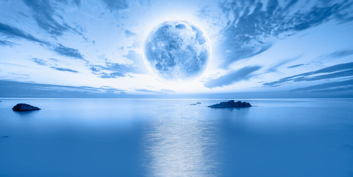 Fantastic landscape with strange stones in the sea with full moon "Elements of this image furnished by NASA"
