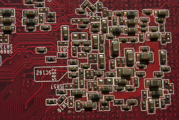 electronic components resistors and capacitors on red pcb