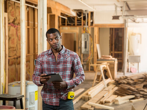Worker using tablet computer at construction site