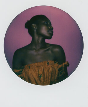 Polaroid print of a beautiful black woman against a purple background