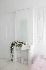 white interior flowers. white mantelpiece with flowers