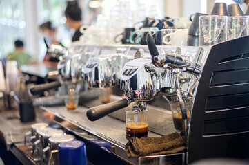 coffee machine making black coffee and pouring into a cup at cafe