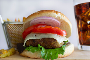Cheeseburger with Fries and Cold Cola on Wood Board , on White Background