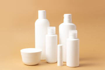 Set of white cosmetic bottles and jars with place to add text