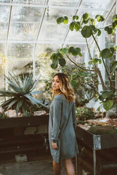 Young Beautiful Asian American Woman Walking In Greenhouse Conservatory