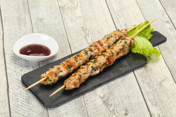 Minced pork skewer kebab with sauce