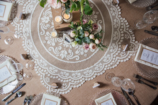 A pretty wedding table, decorated with lace, hessian and flowers, from above