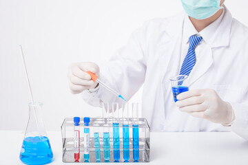 Fototapeta premium close up of cientist is testing and researching some blue liquid chemical in laboratory isolated white background.