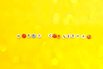 Christmas composition minimalism, letters merry christmas on yellow background