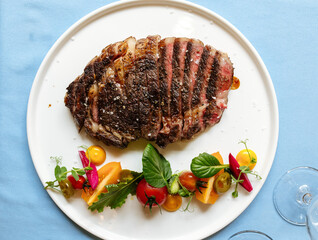 Ribeye beef steak with fresh vegetable salad