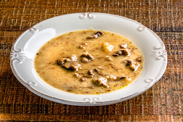 Yam soup in white dish on wooden table