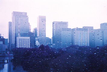 View of Tokyo city buildings and raindrops on wet, rainy, winter day