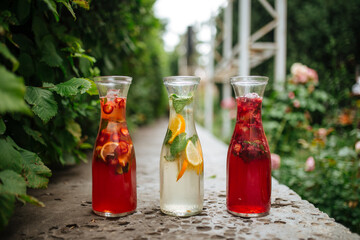 Side view on three fruit and berry lemonades 