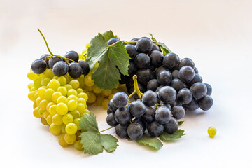 Black and yellow grapes on a white background