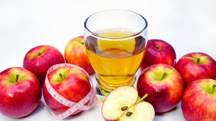 Naklejka na ściany i meble apple cider vinegar,apple and apple juice with tape measure on white background, healty food, drink for weight control in summer. 