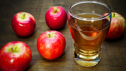 Apple cider vinegar in glass with apples on a wooden background.Selective focus.