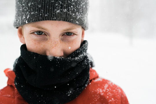 boy in snow with cowl and hat