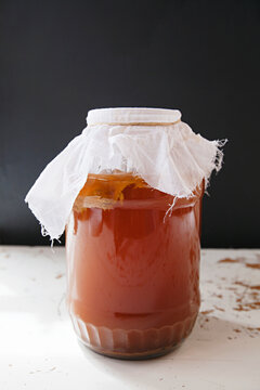 Home brew glass jar of kombucha tea with scoby