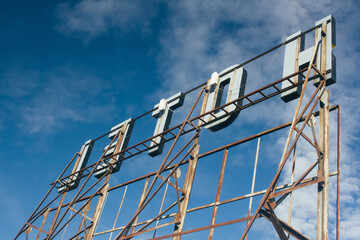 Reverse Of A Hotel Sign And Blue Sky.
