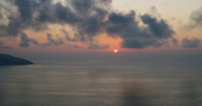 Sunset over sea on ionian Island in Geece. Slow moving clouds above