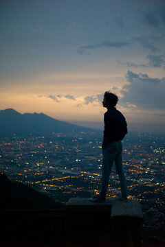 Silhouette of man by city light