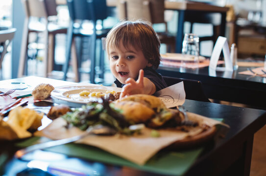 1 year old boy eating a burger