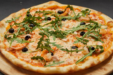 Delicious Italian seafood pizza on dark background