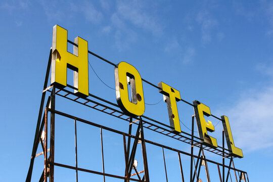 Yellow Hotel Sign Letters Broken And Blue Sky.