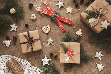Zero waste Christmas flat lay with gifts in kraft paper. Natural wrapping. Boxes with gifts in reusable sustainable recycled paper with twine on sackcloth. Eco friendly homemade new year decor