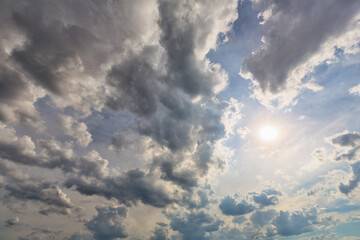 Cumulus clouds and sun in the sky