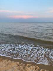 Small waves on the beach in the evening sunset time cost of Azov sea in Russia