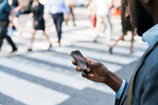 Businessman using a phone in the city