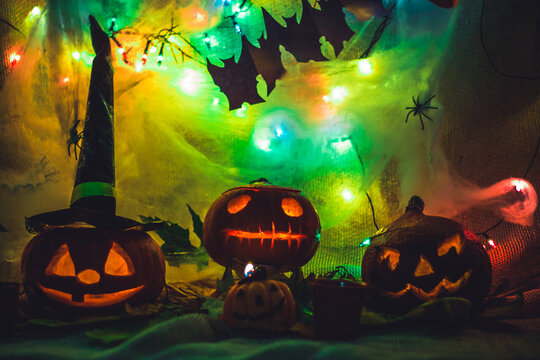 Halloween party decoration carved pumpkin spooky scary faces with light in a dark