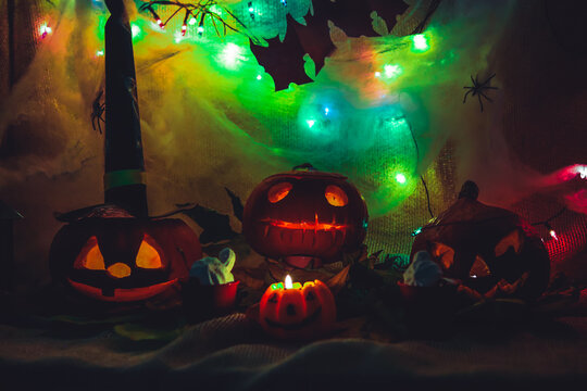 Halloween party decoration carved pumpkin spooky scary faces with light in a dark