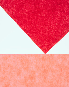 Detail of red and pink sheets of construction paper