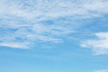 Blue sky background and white clouds soft focus, and copy space