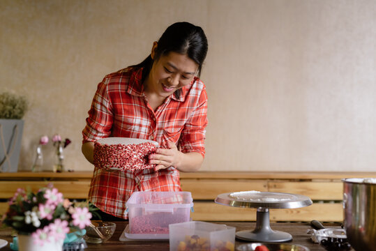 Young woman making a birthday cake