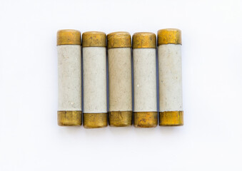 Old electric high-voltage fuses on a white background.