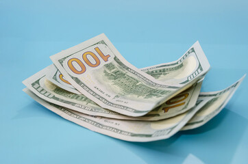 American dollar bills on a blue background.