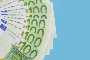 100 euro banknotes fanned out on a blue background. .Financial concept.