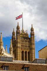 Fototapeta na wymiar Union Jack flies over the Houses of Parliament in Whitehall, London