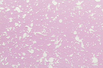 Decorative plaster. Finishing off pink painted wall by particle white plaster. Textured background.