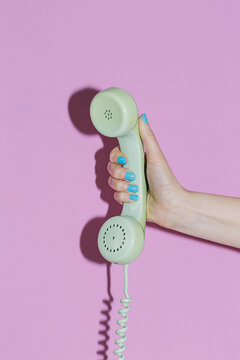 Hand with a telephone handset