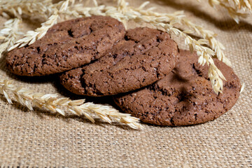 Three chocolate oatmeal cookies on a napkin homemade baking concept and as an advertisement