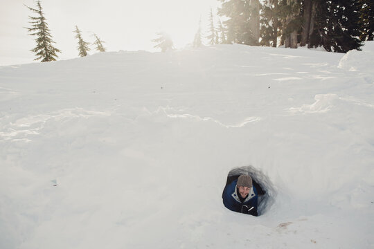 adult playing in snowfort