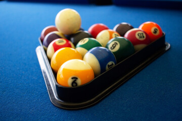 Billiard balls grouped togheter on a plastic triangle.