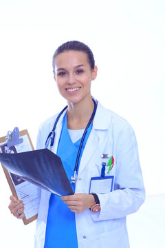 Young female doctor looking at the x-ray picture isolated on white background. Woman doctor
